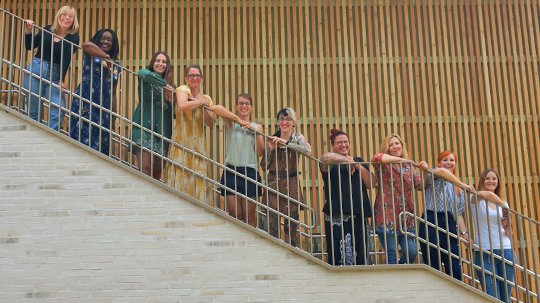 Team der evangelischen Kita Hermannswerder auf einer Treppe