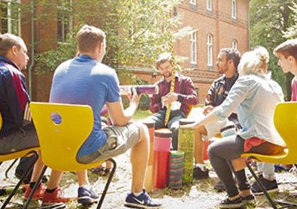 Junge Menschen sitzen im Freien zusammen